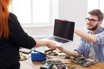 Engineer taking broken laptop from client