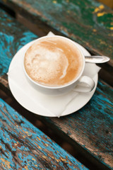 Cup of coffee on wood table outdoor