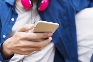 closeup of the young man's hands with the mobile phone