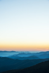 Obraz premium Glorious Sunrise over the Great Smoky Mountains layered blue ridges to the orange yellow horizon