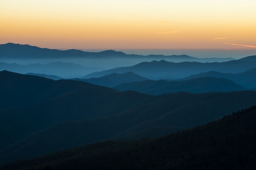 Fototapeta premium Glorious Sunrise over the Great Smoky Mountains layered blue ridges to the orange yellow horizon