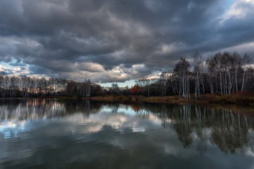 Naked autumn trees on the shore of the lake