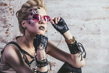 Woman beautiful model with body art of unusual and fashionable clothing in the Studio