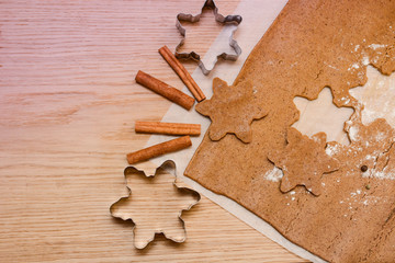 Homemade gingerbread cookies dough, cinnamon and bakery tools. New year, Christmas, winter and cooking background with copy space
