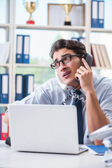 Young businessman under pressure in office to deliver tasks