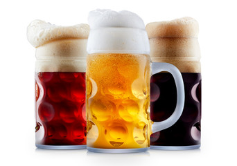 Mug collection of frosty dark red and light beer with foam isolated on a white background