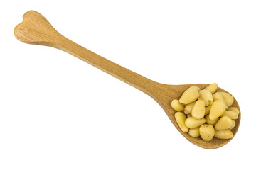 pine nuts on a wooden spoon