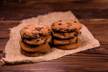 Chocolate chip cookies on sackcloth on a wooden table