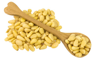 pine nuts on a wooden spoon
