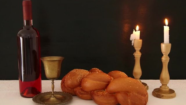 shabbat footage. challah bread, shabbat wine and candles on the table