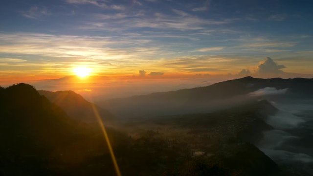 Sunrise nature landscape of Java island in Indonesia. Clouds, mountains and fog. Panning shot, UHD 4K