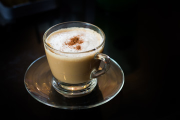 Coffee in a glass cup with black background