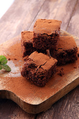 Cake chocolate brownies on wooden background with mint