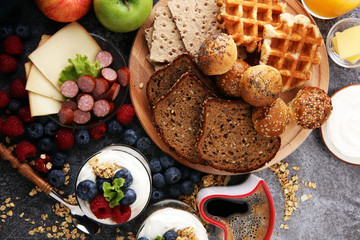Breakfast served with coffee, orange juice, bread, parfaits and fruits. Balanced diet