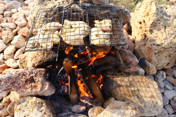 food on bonfire at sea coast