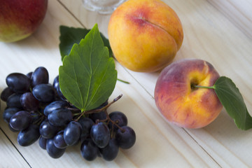 Fruit of the fall of autumn. apples, pears, blue grapes, peaches and juicе.background. fruit with green leaf
