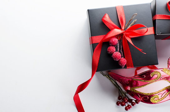 Black christmas  gift  box with red ribbon and nask
