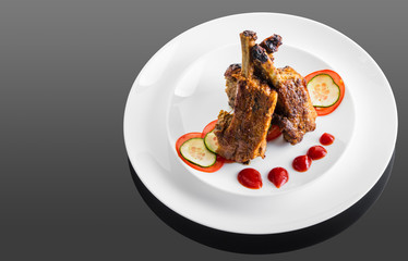 fried ribs with sauce and vegetables