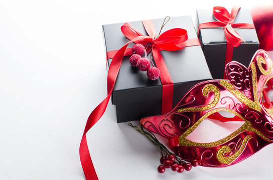 Black christmas  gift  box with red ribbon and nask
