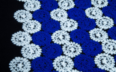 warm fleecy fabric with white and blue flowers, circles on a black background