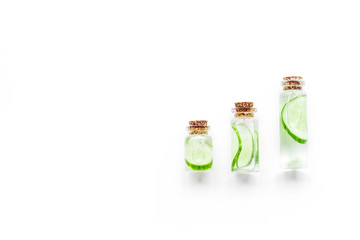 Fresh organic cosmetics with cucumber. Lotion on white background top view copyspace