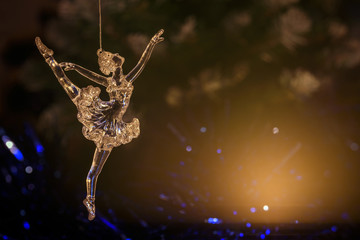 Glass ballet dancer on Dark background. Old style. Selective focus