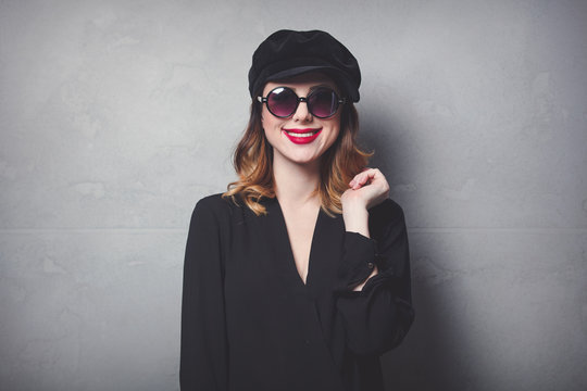 Style redhead girl in black hat and clothes