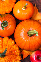 Harvest or Thanksgiving background with pumpkins, apples and fallen leaves. Halloween, Thanksgiving day or seasonal autumnal concept.