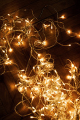 Christmas lights garland on dark background. Christmas card with copy space for greeting text.