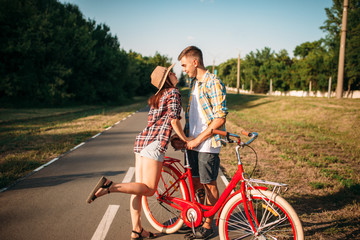 Love couple with vintage bicycle walking in park