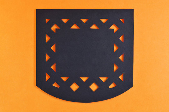 dark mexican perforated paper on orange background