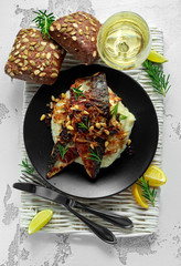 Sicilian style mackerel on cauliflower puree with caramelized onions, pine nuts served with rustic bread and white wine
