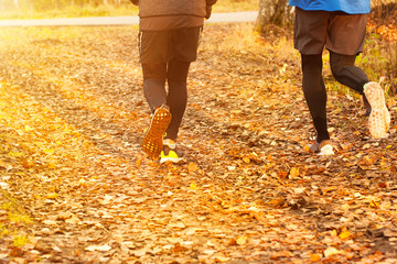 two jogging friends in autumn park