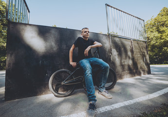 Bmx rider performing tricks at skatepark.