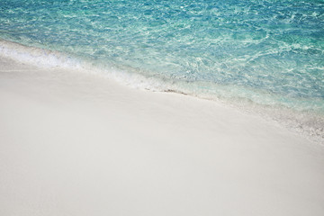 Soft wave of blue ocean on sandy beach. Background
