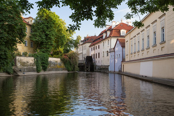 Fototapeta na wymiar Old buildings and water canal on the Kampa Island in Prague, Czech Republic on a sunny day in the summer.