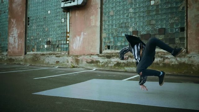 Hip-hop and breakdancing. Breakdancer dancing in the street. Slow motion. HD
