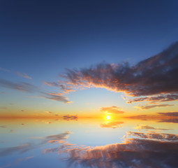 Beautiful sunset over the ocean with dramatic autumn sky. Abstract natural composition
