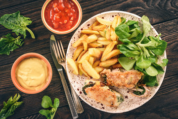 Pork roulades with spinach and cheese filling, served with fried potatoes.