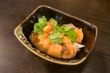 Delicious  portion of fresh salmon fillet  with aromatic herbs, spices and vegetables - healthy food, diet or cooking concept