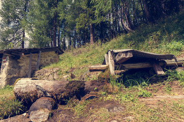 Old wooden fountain in the mountain .