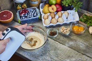 Closeup of electric mixer with whipped smooth dough for cake