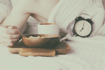 Young man having Breakfast in bed in the morning