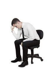 Stressed businessman with a chair on studio