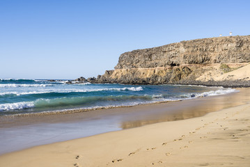 Fototapeta na wymiar Remote surfers bay, beach at the west coast of Fuerteventura, Canary Islands.