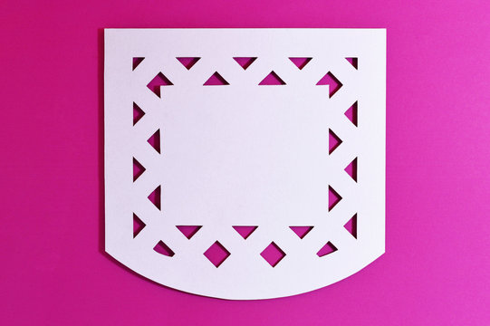 white mexican perforated paper on pink background