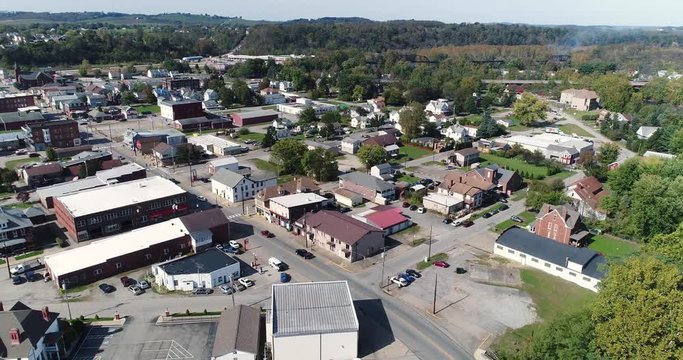 A slowly moving forward aerial shot of the business district of Connellsville, Pennsylvania, a small town in Southwestern Pennsylvania.  	