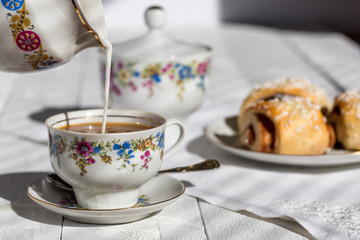 Coffee with milk and rolls