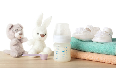 Fototapeta na wymiar Composition with feeding bottle of baby milk formula on wooden table