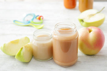 Jars with baby food on table